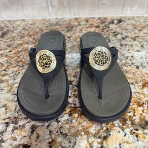Ladies chocolate brown Croc Sandals with Decorative Medallion.  Size 8.